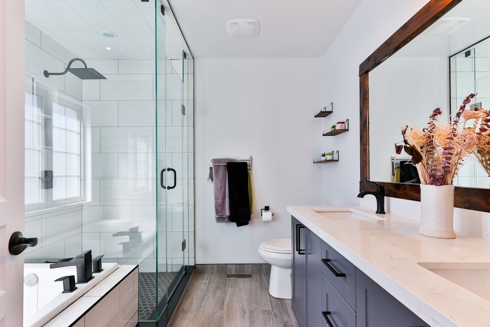 Bathroom with frameless glass shower and double vanity